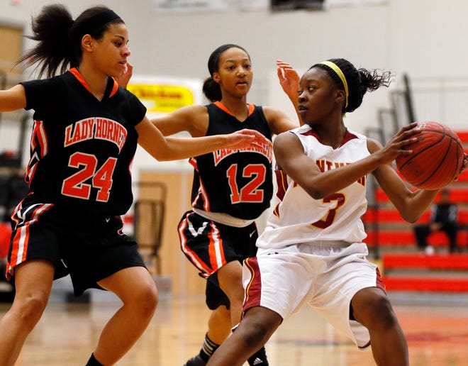 Nakylia Carter (3) of Putnam City North looks to pass away from Kaylan Mayberry (12) and MiKayla Alexander (24) of Booker T. Washington during the championship game of the Lady Jag Classic girls basketball tournament between Booker T. Washington and Putnam City North at Westmoore High School in Oklahoma City, Saturday, Jan. 12, 2013. Photo by Nate Billings, The Oklahoman