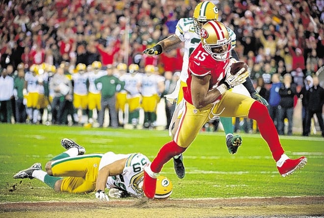 San Francisco 49ers' Michael Crabtree drives past Green Bay Packers' Brad Jones for a touchdown in the second quarter.
