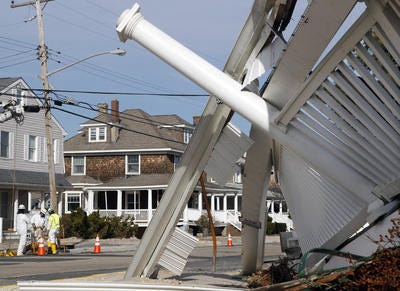 A utility crew works near a home left severely damaged two months ago by Superstorm Sandy in Bay Head, N.J.  (AP Photo/Mel Evans)