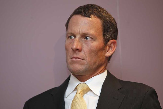 FILE - In this Feb. 28, 2011 file photo,Lance Armstrong sits during a news conference at the Cedars-Sinai Hospital in Los Angeles. The IOC formally opened an investigation Thursday, Nov. 1, 2012, that could result in Lance Armstrong losing his Olympic bronze medal for doping. Cycling's governing body, the UCI, last week formally stripped Armstrong of his seven Tour de France titles from 1999-2005. Armstrong could also lose the bronze medal he won in the road time trial at the 2000 Sydney Olympics. (AP Photo/Damian Dovarganes)
