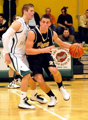 Archbishop Wood's T.J. Kuhar (21) drives down court as Lansdale Catholic's Kyle Pavlik (23) attempts to stop him during Sunday afternoon's game against Archbishop Wood at Lansdale Catholic High School.