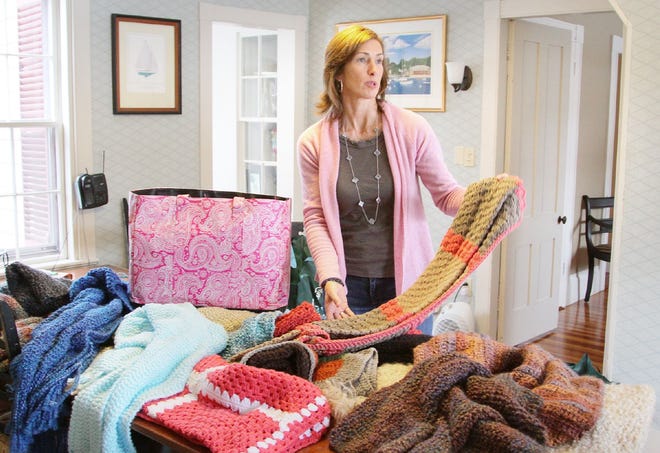 Amy Holbrook packs prayer shawls for residents of Newtown, Conn., at her home in Duxbury on Wednesday, Jan 9, 2013.