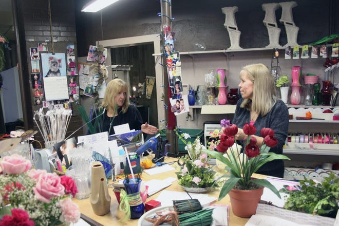 Sue Presswood (left) and Flowers Are Us owner Jane Switzer love their creative work. Presswood started working at Flowers Are Us, 123 S. 1st St., a few months after it opened in 1983.