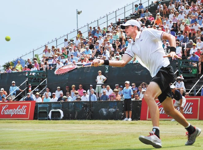 John Isner returns a shot in front of the Campbell’s billboards during last year’s Hall of Fame Tennis Championships in Newport. Campbell’s had been the title sponsor of the only grass-court ATP World Tour event in North America since 2004. In July Isner, the two-time defending champion, will return to play in the Hall of Fame Tennis Championships, which has replaced Campbell's with an array of sponsors.