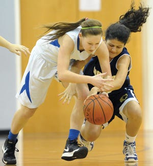 Burlington Christian Academy's Morgan Ivey, left, and Trinity School's Lina Habib scramble for a loose ball during Tuesday's game.