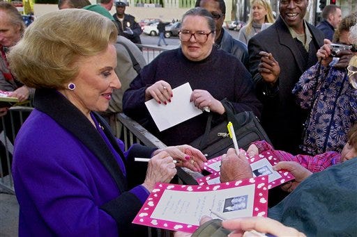 In this Feb. 14, 2001 file photo, "Dear Abby" advice columnist Pauline Friedman Phillips, 82, known to millions of readers as Abigail van Buren, signs autographs for some of dozens of fans after the dedication of a "Dear Abby" star on the Hollywood Walk of Fame in Los Angeles. Phillips, who had Alzheimer’s disease, died Wednesday, Jan. 16, 2013, she was 94.