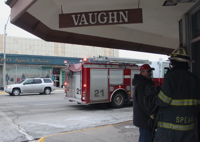 Vaughn Jewelers owner Tom Scudder talks with Monmouth Assistant Fire Chief Pat Spears Wednesday afternoon outside the store located at 200 S. Main St.