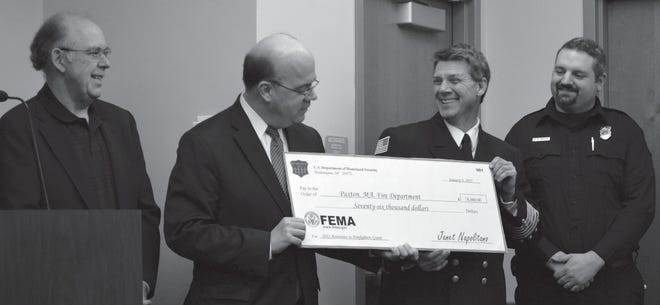 From left, Paxton selectman John Malone, U.S. Rep. James McGovern, Paxton Fire Chief Jay J. Conte and Paxton Fire Lt. Michael Pingitore with the check representing the grant award to the town.