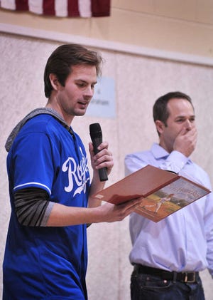 Kansas City Royals pitcher Aaron Crow reads to students at Auburn Elementary on Thursday as part of the Royals caravan. Crow attended Auburn Elementary until sixth grade.