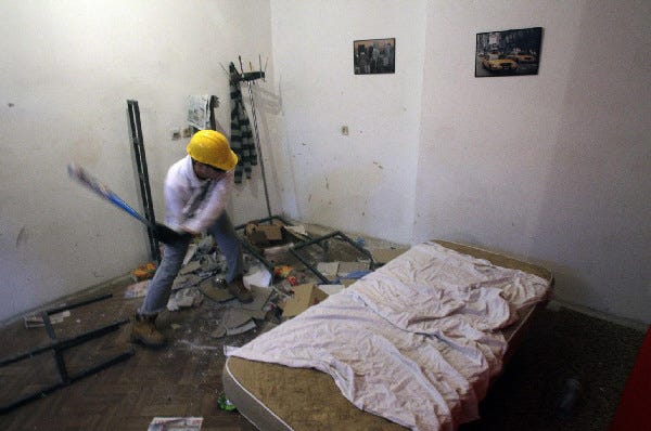 Savo Duvnjak smashes furniture and other household items during a demolishing session at the Rage Room, in Novi Sad, Serbia.
