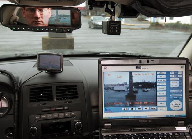 Ben Goff / The Gazette) Gastonia police officer Mike Rudisill views footage from the dashboard camera mounted in his patrol car while demonstrating it's operation on Wednesday January 16, 2013. The feed from the camera, as well as one mounted in the back seat to record persons being transported, can be viewed on the mobile data terminal (MDT) computer or on a monitor in the rear-view mirror.