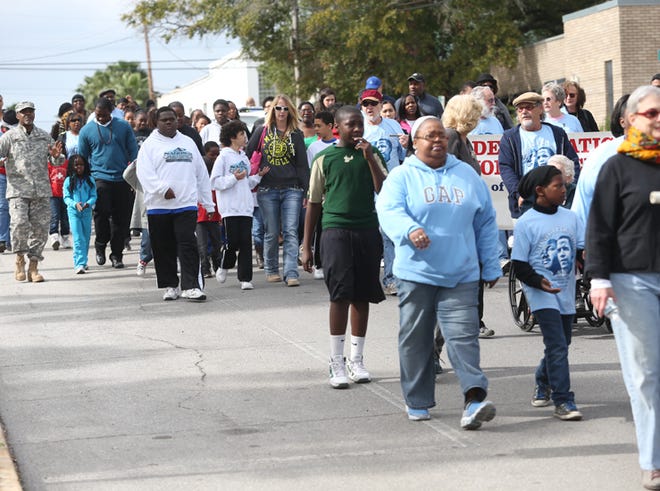 The group marches to honor Martin Luther King Jr. on Saturday near the Bay County Courthouse.