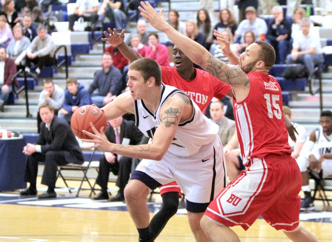 Ioanna Raptis/Portsmouth Herald photo



UNH’s Chris Pelcher, left, looks for an open teammate while double teamed against Boston University on Saturday afternoon in Durham.