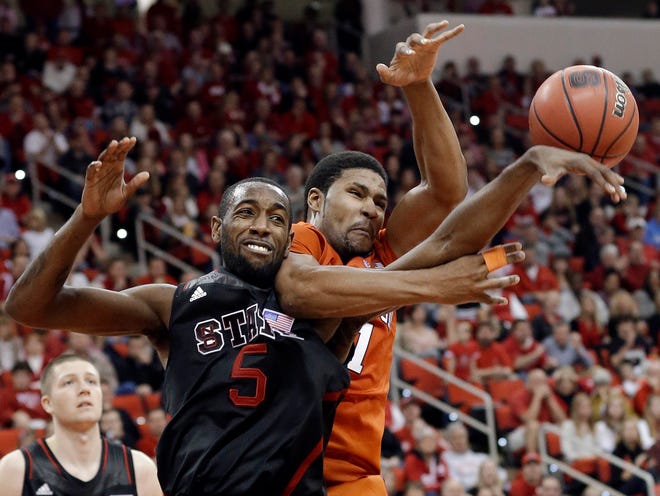 N.C. State's C.J. Leslie (5) and Clemson's Devin Booker battle for the ball on Sunday in Raleigh, N.C.