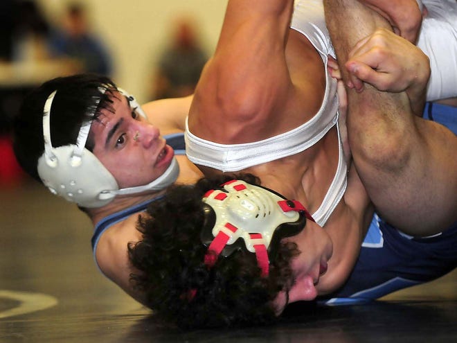 Dorman’s Hector Contreras, bottom, won the 120-pound title match at the Spartanburg County meet on Saturday at Spartanburg High School.