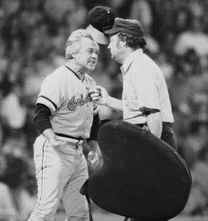 In this July 13, 1974 file photo, Baltimore Orioles manager Earl Weaver literally "flips his lid" as he protests a call by home plate umpire Marty Springstead during a baseball game against the Chicago White Sox in Chicago. Weaver, the fiery Hall of Fame manager who won 1,480 games with the Baltimore Orioles, has died, the team announced Saturday, Jan. 19, 2013. He was 82. (AP Photo/File)