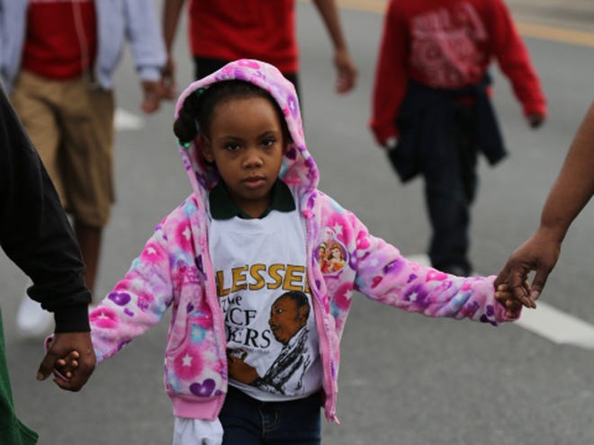 Marchers participate in the annual Martin Luther King Day march in Ocala on Monday.