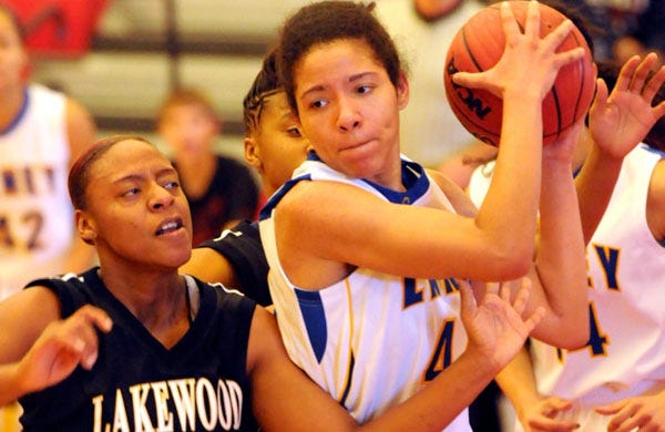 Laney’s Amber Doniere comes down with the rebound in front of Lakewood’s Teisha Rich during the first half of play Monday. Laney defeated Lakewood 58-26 during the MLK Jamboree at Union High School.