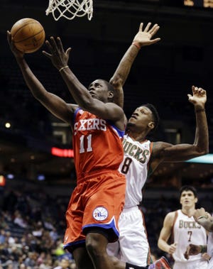 Philadelphia's Jrue Holiday shoots against Milwaukee's Larry Sanders during the Tuesday's game in Milwaukee.