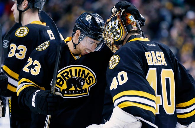 Boston Bruins' Chris Kelly (23) celebrates with teammate and goalie Tuukka Rask after the Bruins defeated the Winnipeg Jets 2-1 in a shootout during an NHL game in Boston, Monday, Jan. 21, 2013.