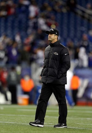 Baltimore Ravens coach John Harbaugh walks on the field Sunday before the AFC Championship against the New England Patriots.