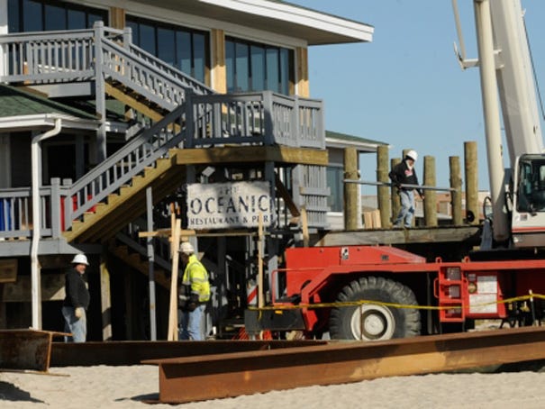 Construction crews unload large wooden and metal beams Tuesday Jan. 22, 2013 as the renovation of Crystal Pier began earlier this week in Wrightsville Beach.
