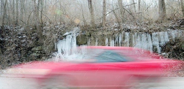 A car whizzes by icicles along Main Street in Wampum Monday afternoon.