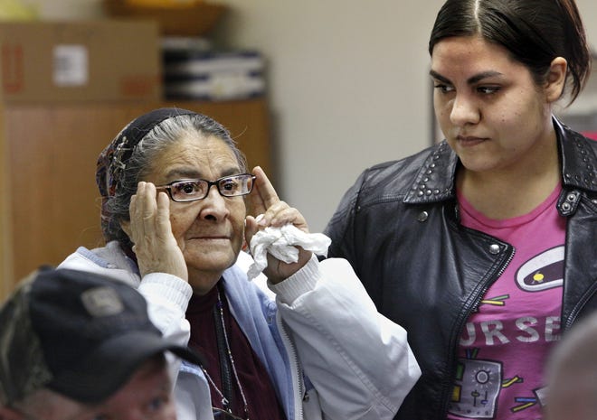 Guadalupe Fuentes, left, adjusts a new set of eyeglasses as she reads an eye chart to her daughter, Rosa Rodriguez, as Fuentes tries different pairs of glasses. Photos by Jim Beckel, The Oklahoman