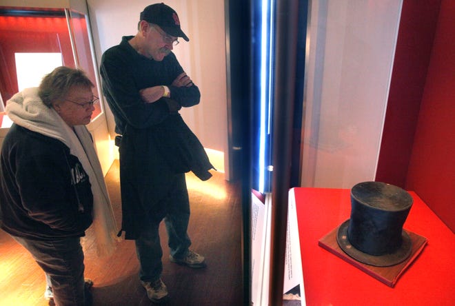 On Wednesday, Dave and Carla Block of St. Louis get a closeup look at Abraham Lincoln's famed stovepipe hat, which went on display in the Treasures Gallery at the Abraham Lincoln Presidential Library and Museum on Wednesday, Jan. 23, 2013. Exhibited in a separate case nearby, a small scrap of paper in Lincoln's hand that might have been stored in the hat spoke of his idea of democracy: "As I would not be a slave, so I would not be a master. This expresses my idea of democracy." Scheduled to be on display for the next six months, the beaver-fur hat features two bare patches in the brim-marks made by the continual fingering by Lincoln's hand when he lifted the hat in recognition of those passing by.