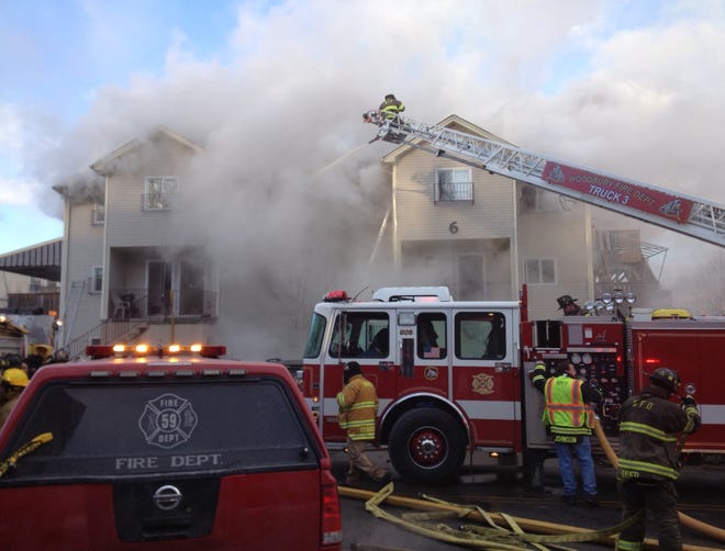 Firefighters work at the scene of a fire in Kiryas Joel Wednesday afternoon.