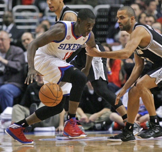 The Sixers' Jrue Holiday (11) drives against the Spurs' Tony Parker during Monday night's game at the Wells Fargo Center.