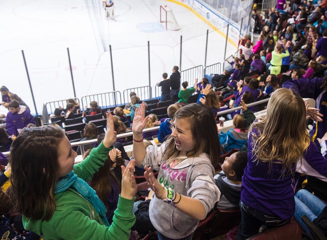 Canton Ingersoll Middle School fifth graders Karsyn Woerly, left, and McKenna Gan, right, party like it's 2013 as 7,832 kids from more than 50 area schools pack the Peoria Civic Center for a mid-morning Rivermen Faceoff Field Trip game Wednesday. Goalie Jake Allen made 27 saves and the Rivermen played a strong defensive game to shut out the Chicago Wolves, 2-0.