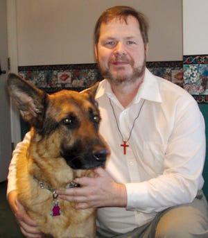 Pastor David Fish, pictured with his dog “Pastor,” has been settling into new duties at the First Congregational Church.