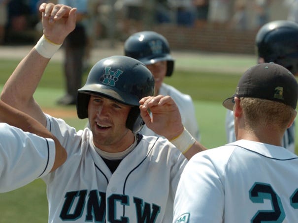 Lee McLean is greeted by teammates after scoring in the ninth inning against Virginia Commonwealth on May 28, 2006. StarNews file photo