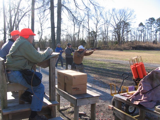 A shooter takes aim on a clay pigeon while others wait their turns at the Craven County Law Enforcement Officers Association's trap shooting range.