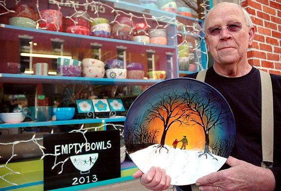 Roscoe Whitfield made this large bowl as an invitation to other people to paint and donate a bowl for the Empty Bowls fund-raiser. His bowl is on display with many others in the window of The Accidental Artist on Craven Street in New Bern.