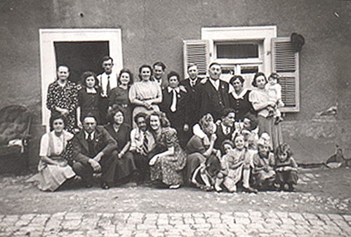 A photo of the entire Weydert family in front of the farmhouse in Buschdorf, Luxembourg, saved from German marauders by American soldiers, including Pvt. Thomas C. Pierce of Kewanee, in World War I. The picture was taken around 1923 but the damages of the war are still visible on the home. ‘If it hadn’t been for Thomas Pierce and his regiment arriving at the right moment, pushing back the Germans, I probably wouldn’t exist today,’ said Andre Meyer, great-grandson of Mr. Weydert, fourth from the right in the second row.