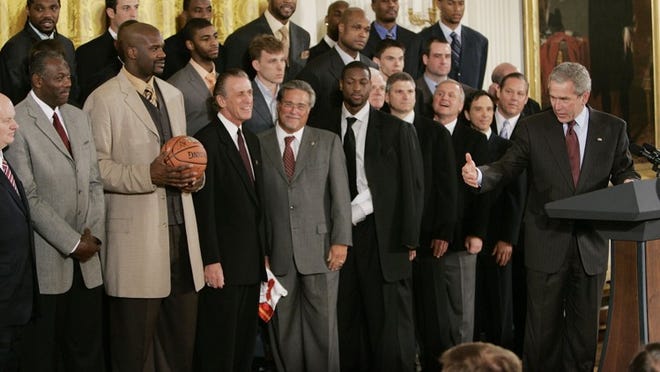 President Bush, right, takes part in an ceremony honoring the NBA Champion Miami Heat basketball team, Tuesday, Feb. 27, 2007, in the East Room at the White House in Washington. From third from left are, center Shaquille O’Neal, coach Pat Riley, owner Micky Arison and guard dwyane Wade. (AP Photo/Ron Edmonds) ORG XMIT: WHRE111