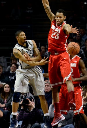 Penn State's Jermaine Marshal (left) passes around Ohio State's Amir Williams (23) during the second half of Saturday's game in State College, Pa.. Ohio State won 65-51.