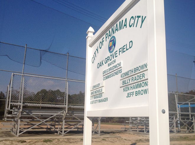 The city plans to clear the wooded area behind the Oak Grove Field for a neighborhood park.