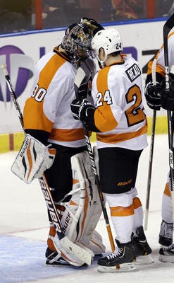 Philadelphia Flyers' Matt Read (24) and goalie Ilya Bryzgalov (30) celebrate after the Flyers' 7-1 win over the Florida Panthers in an NHL hockey game in Sunrise, Fla., Saturday, Jan. 26, 2013. (AP Photo/Alan Diaz).
