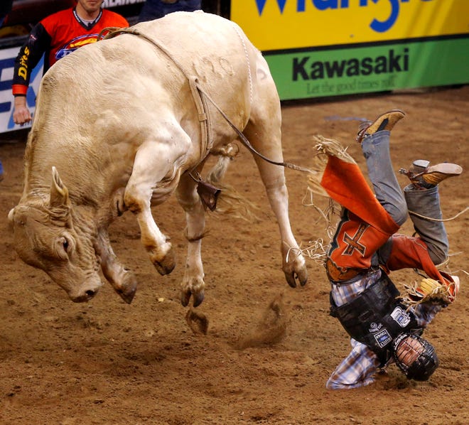 Brant Atwood hits the ground after finishing his ride on Blonde Bomber during the WinStar World Casino Invitational PBR bull riding event at Chesapeake Energy Arena in Oklahoma City, Saturday, Jan. 26, 2013. Photo by Bryan Terry, The Oklahoman
