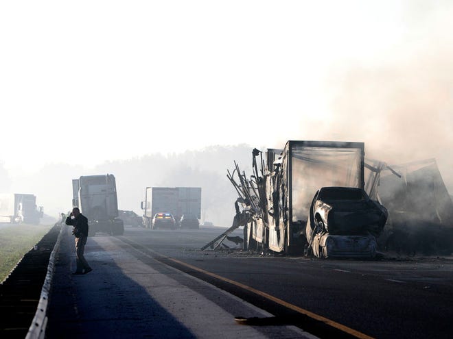 Smoke from burning trailers at the scene of a multi-vehicle wreck on Interstate 75 at Paynes Prairie on Sunday, Jan. 29, 2012, south of Gainesville.