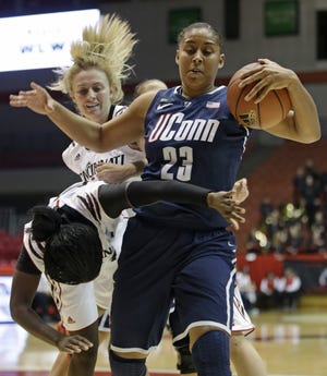 Connecticut forward Kaleena Mosqueda-Lewis (23) pulls a rebound away from Cincinnati guard Dayeesha Hollins, left, while guard Kayla Cook watches in the first half of an NCAA college basketball game on Saturday, Jan. 26, 2013 in Cincinnati. ()