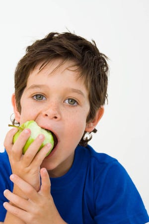 Boy biting apple