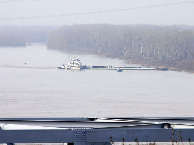 The towboat Nature Way Endeavor banks a barge against the western bank of the Mississippi River, Sunday, Jan. 27, 2013. The river was closed to all traffic eight miles north and south of Vicksburg.