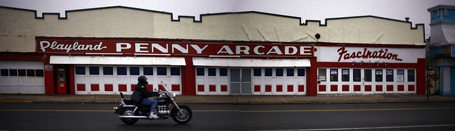 A motorcyclist rides past the Playland Penny Arcade on Nantasket Avenue in Hull.