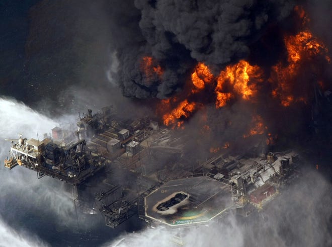 In this April 21, 2010 aerial file photo taken in the Gulf of Mexico more than 50 miles southeast of Venice, La., the Deepwater Horizon oil rig is seen burning. A U.S. judge on Tuesday approved an agreement for British oil giant BP PLC to plead guilty to manslaughter and other charges and pay a record $4 billion in criminal penalties for the company's role in the 2010 oil disaster in the Gulf of Mexico.