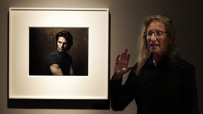 Renown photographer Annie Lebovitz stands next to a portrait she made of Tom Cruise inside the Norton Museum of Art Thursday, January 17, 2013 while talking to media about the thinking behind her work and her upcoming exhibit. (Damon Higgins/The Palm Beach Post)