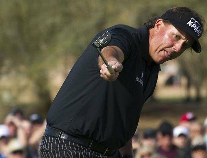 Phil Mickelson watches his birdie putt roll towards the cup on the ninth green during first round of the Phoenix Open golf tournament, Thursday, Jan. 31, 2012, in Scottsdale, Ariz.. Mickelson's putt lipped-out, and he had to settle for par on the hole.